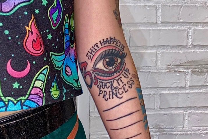 Illawarra local Kittie Humphries’ tattoo: ‘Shit happens. Suck it up princess”, an ironic expression and statement on her experience with others’ response to her mental illness. Photo: Keeley Hurry